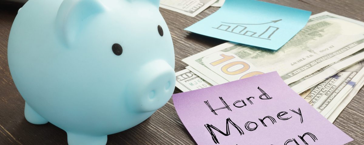 Hard money loan illustrated with cash and a piggy bank