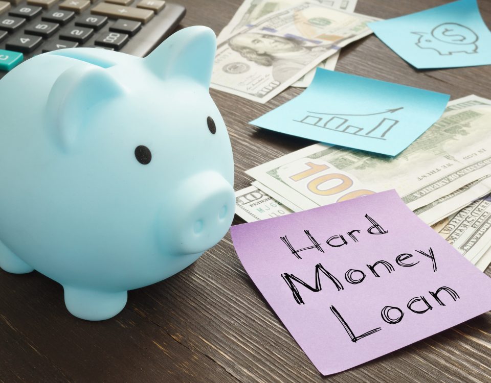 Hard money loan illustrated with cash and a piggy bank